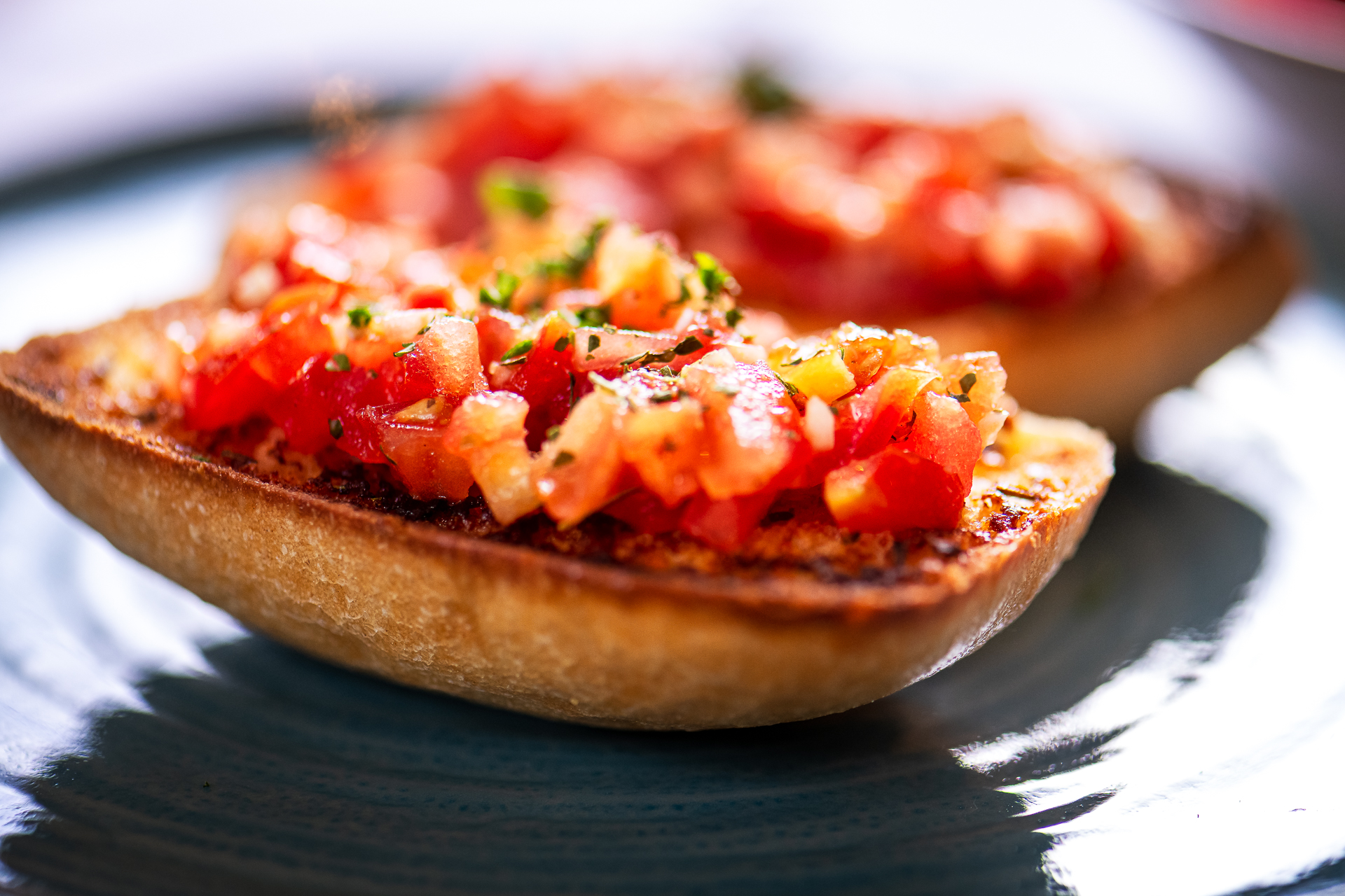 Bruschetta with diced tomatoes and herbs on toasted bread